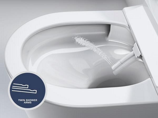A close-up of a GROHE Sensia shower toilet showing the spray arm in operation.