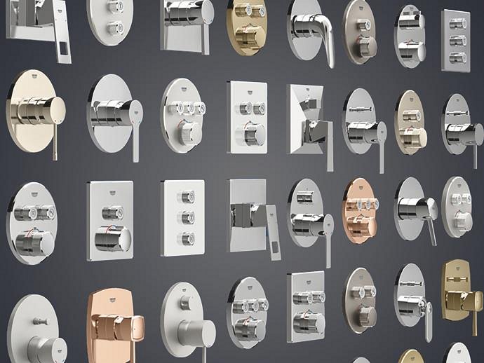 Una vasta gamma di miscelatori termostatici per doccia a incasso GROHE in varie forme e finiture, disposti su uno sfondo grigio.
