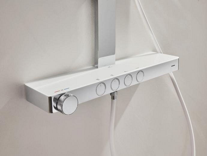 Close-up of the sleek thermostat mounted on a light gray wall.