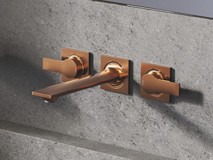 Close-up of modern wall-mounted Allure tap set in Warm Sunset finish.